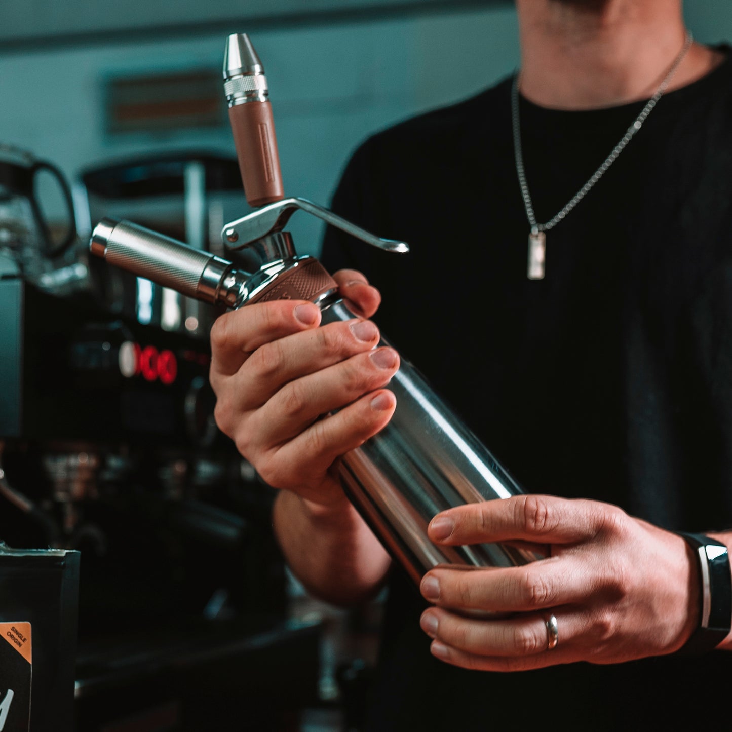 Barista holding Nitro coffee maker